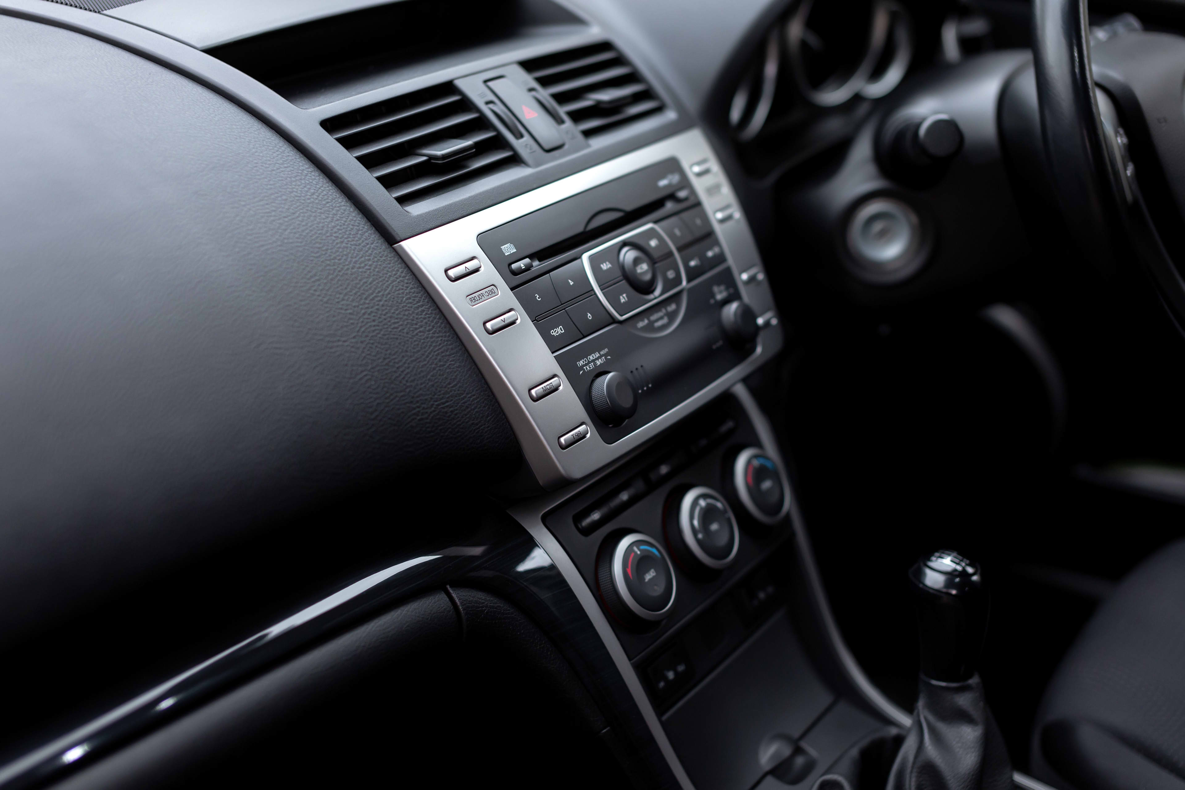 A close-up of a car dashboard showing buttons