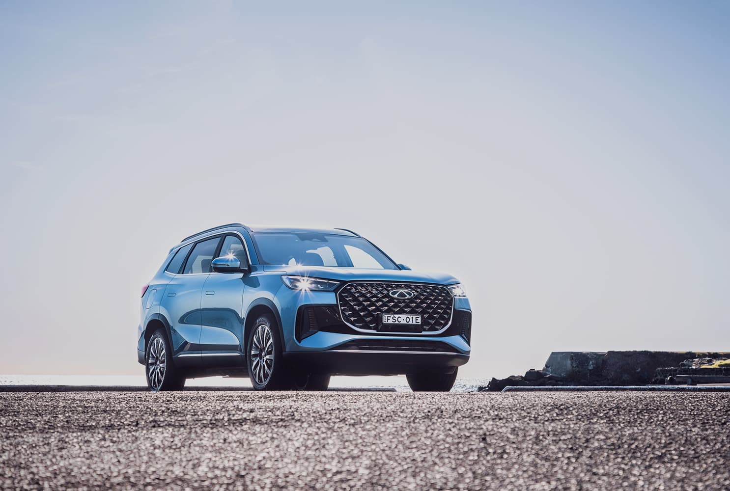A blue Chery Tiggo 8 PHEV SUV on a tarmac