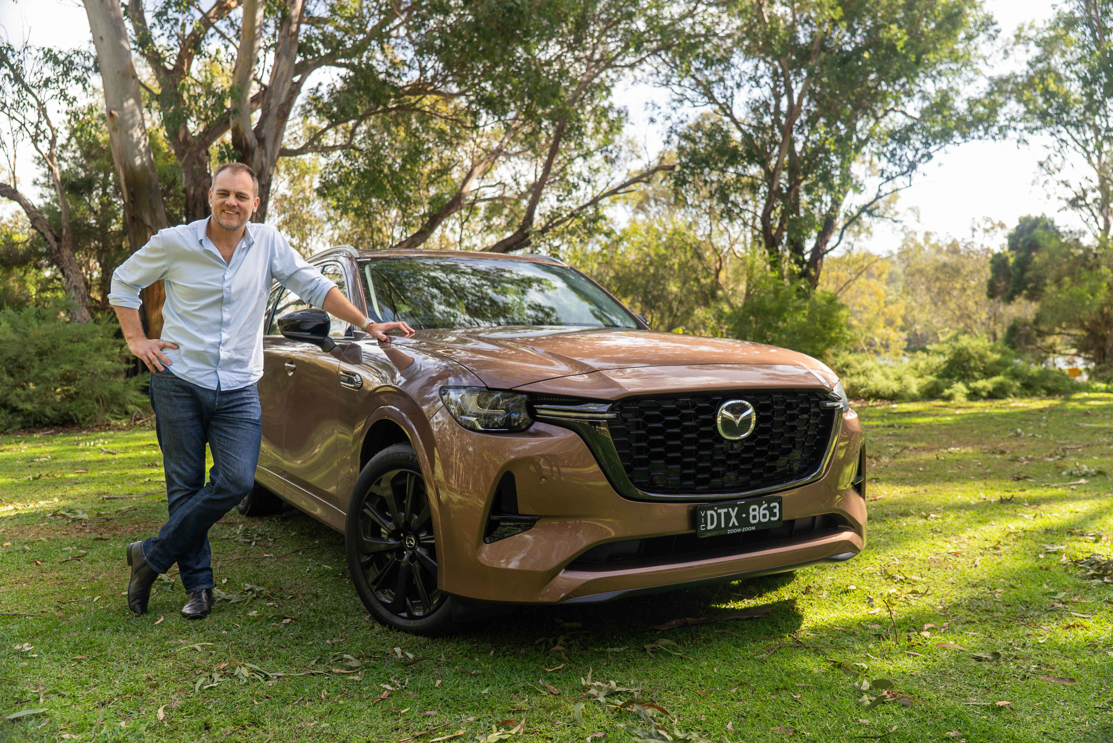 Alex Forrest leaning against the Mazda CX-80