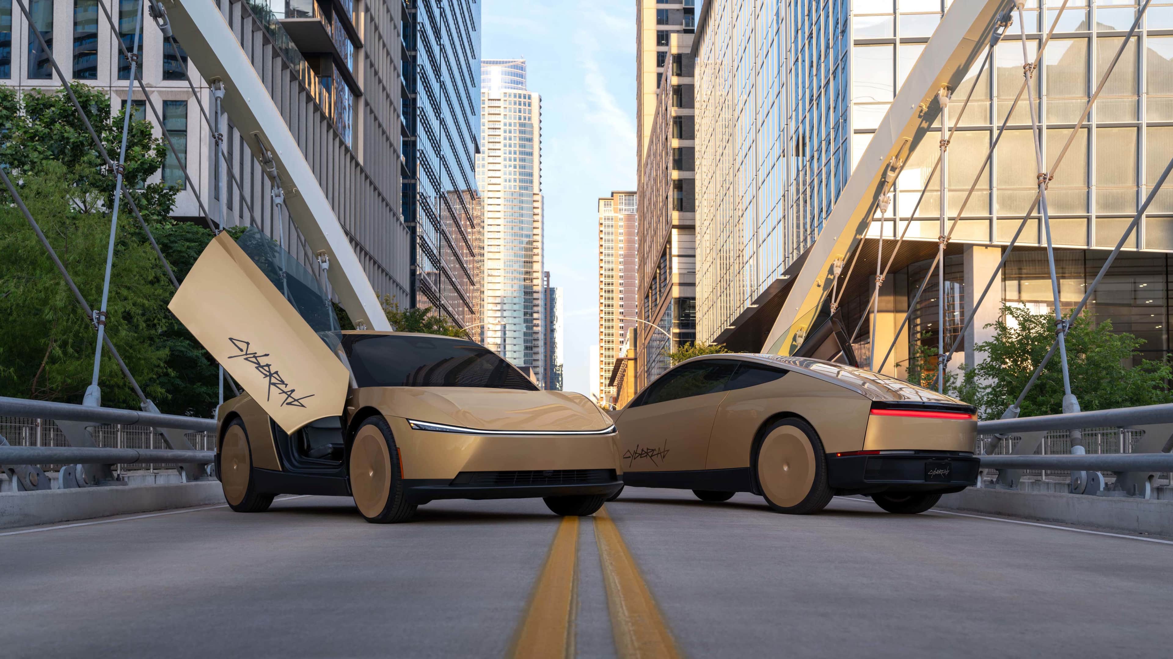 Two gold futuristic looking cars, one with its scissor door open upwards with Cybercab written in black, parked in the middle of a city road with skyscrapers in the background.
